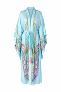 A light blue kimono-style robe with a tie waist belt, featuring ornate gold, purple, and pink floral and bird motifs printed along the front and sleeves, shown against a plain white background.